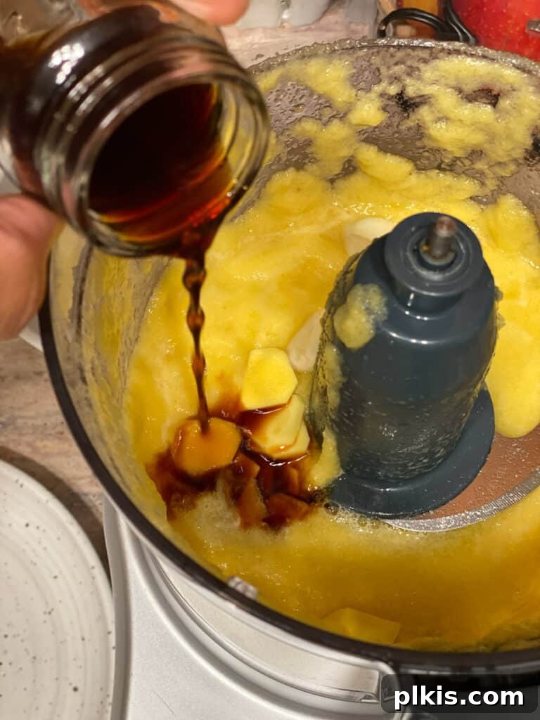 Process shot of adding soy sauce to the food processor for the sweet and sour sauce.
