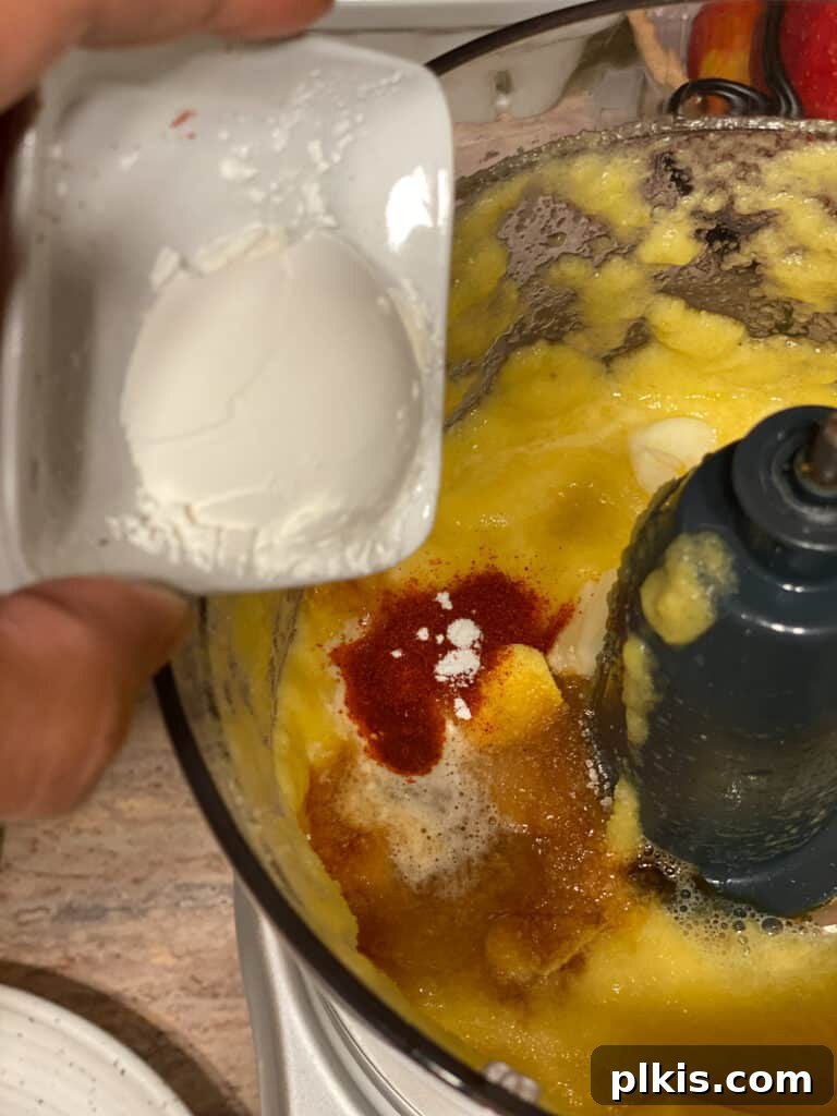 Process shot of adding cornstarch to the food processor for the sweet and sour sauce, to thicken it.