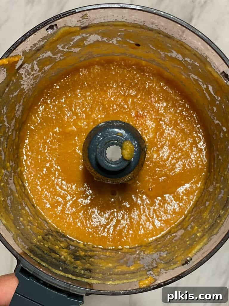 Image of the pineapple mixture after blending in the food processor, showing its smooth consistency.