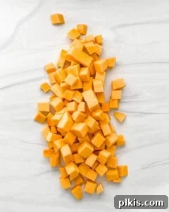 Golden Butternut Curry 4 raw cubed butternut squash on a white marble surface