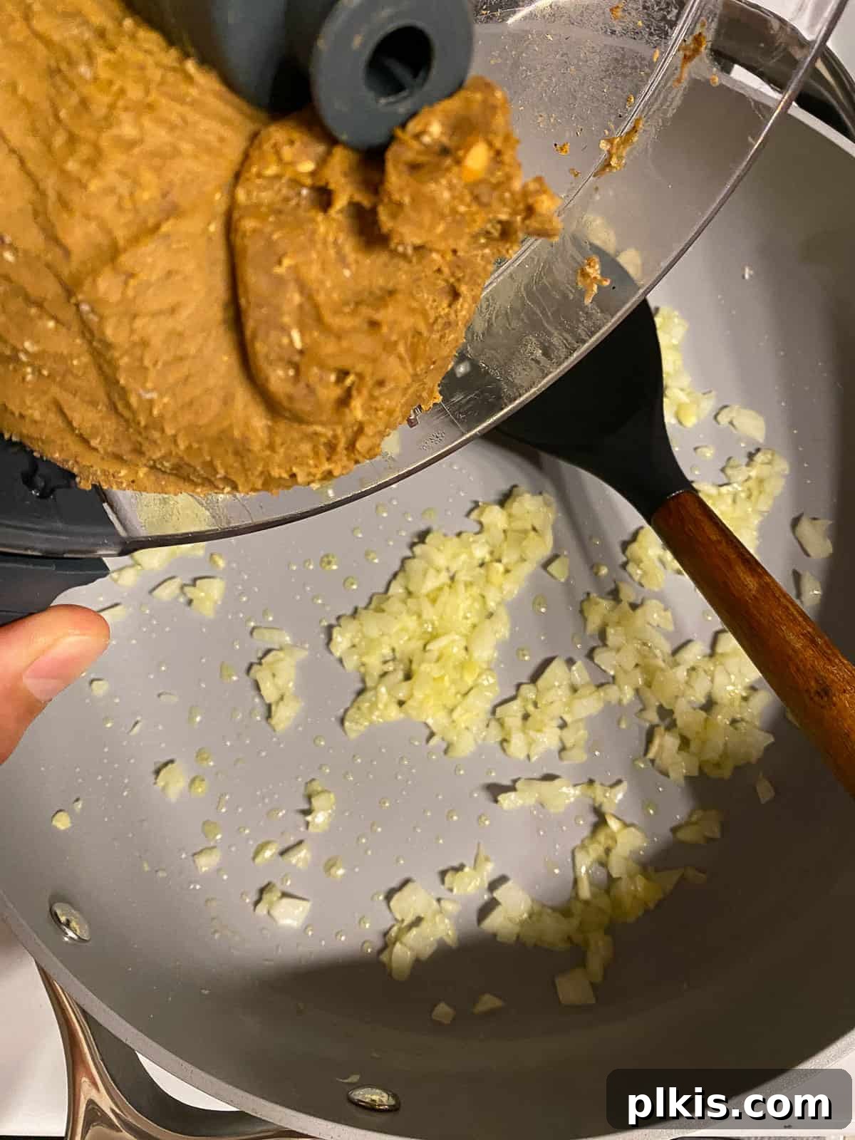 Hearty Plant-Based Lentil Street Tacos 13 process shot of adding filling mixture to pan