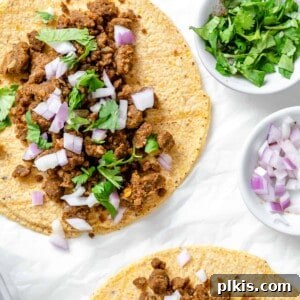 completed Plant Based Street Tacos with Lentils on a white surface with ingredients in the background