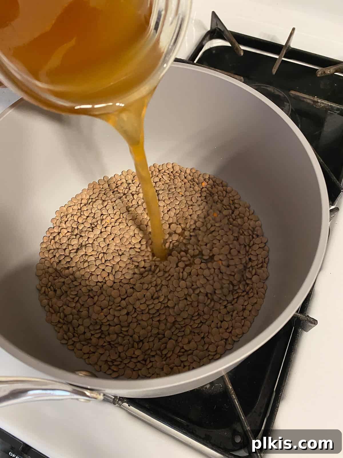 Hearty Plant-Based Lentil Street Tacos 5 process shot of adding veggie broth to a bowl