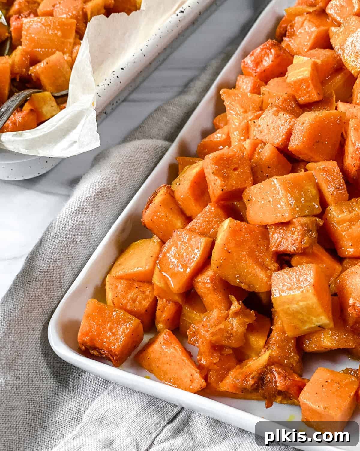 Curried Butternut Squash Roast 2 Finished roasted curried butternut squash on a baking dish, garnished lightly