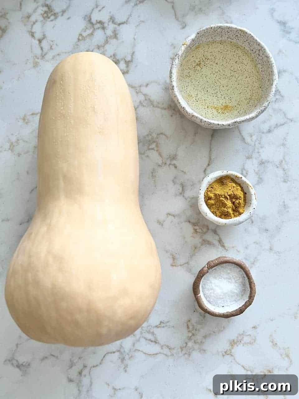 Curried Butternut Squash Roast 3 Raw ingredients for Roasted Curried Butternut Squash: whole squash, oil, curry powder, and sea salt against a white background