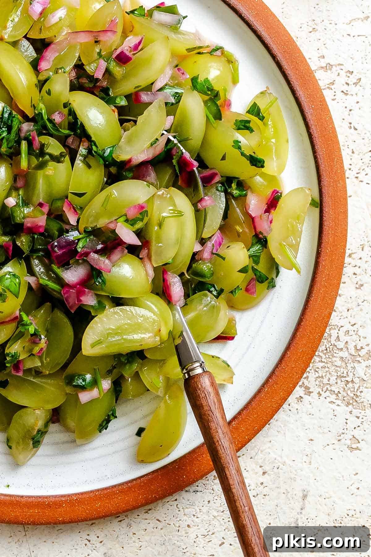 A bowl of vibrant Fresh Grape Salsa, garnished with fresh cilantro, ready to be served.