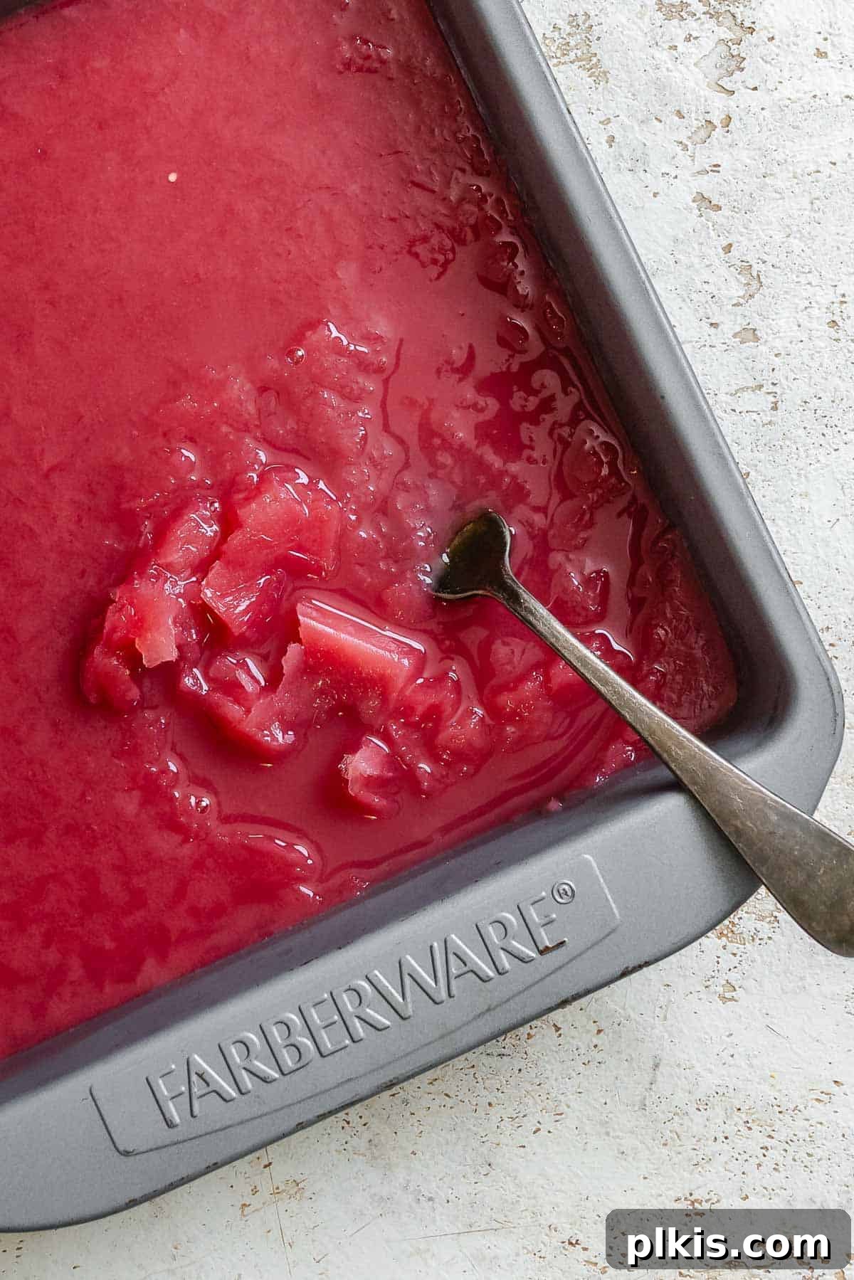 Ruby or Jade Grape Sorbet 8 Process shot showing stirring ingredients in baking dish.
