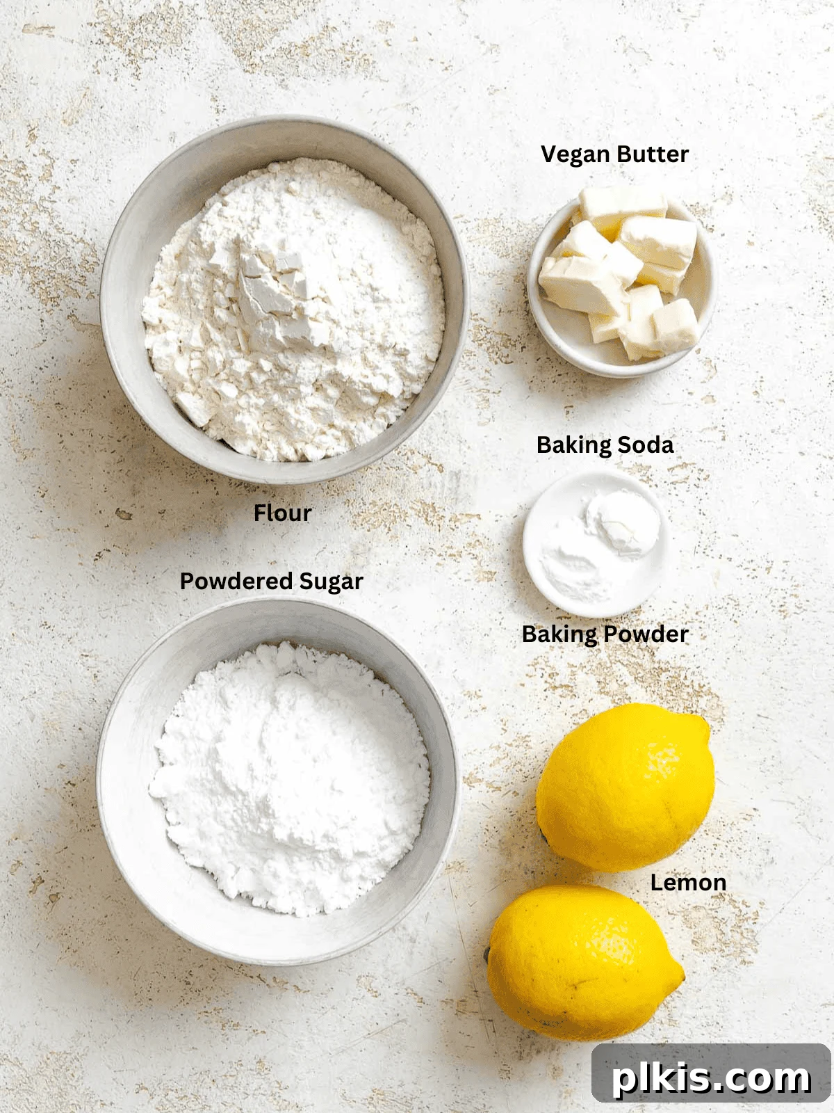 Tangy Lemon Crinkle Delights 3 Carefully measured ingredients for Lemon Crinkle Cookies displayed on a pristine white surface, ready for mixing.
