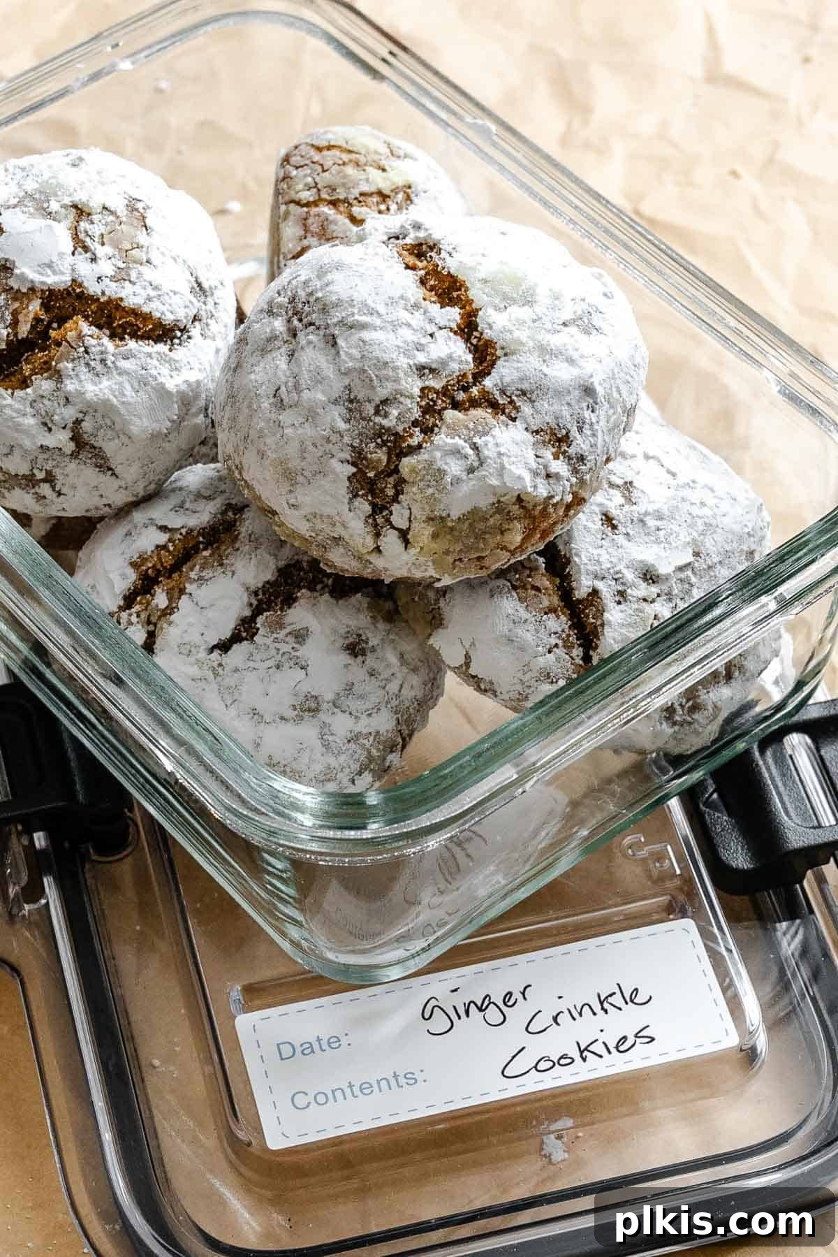 Festive Eggless Gingerbread Crinkle Cookies 11 Completed Gingerbread Crinkle Cookies (Eggless!) in a clear storage container, ready for gifting or keeping.