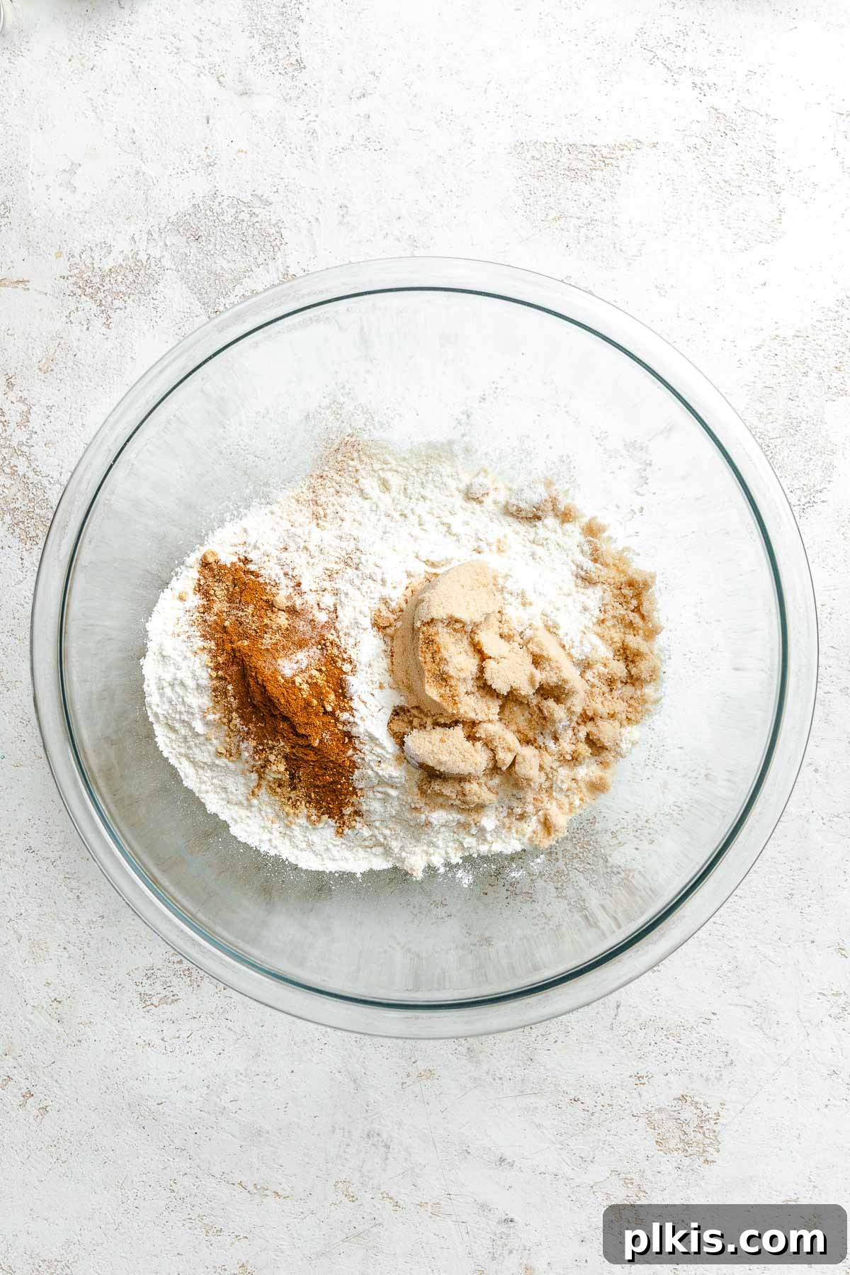 Festive Eggless Gingerbread Crinkle Cookies 4 Process shot showing mixing dry ingredients together in a bowl.