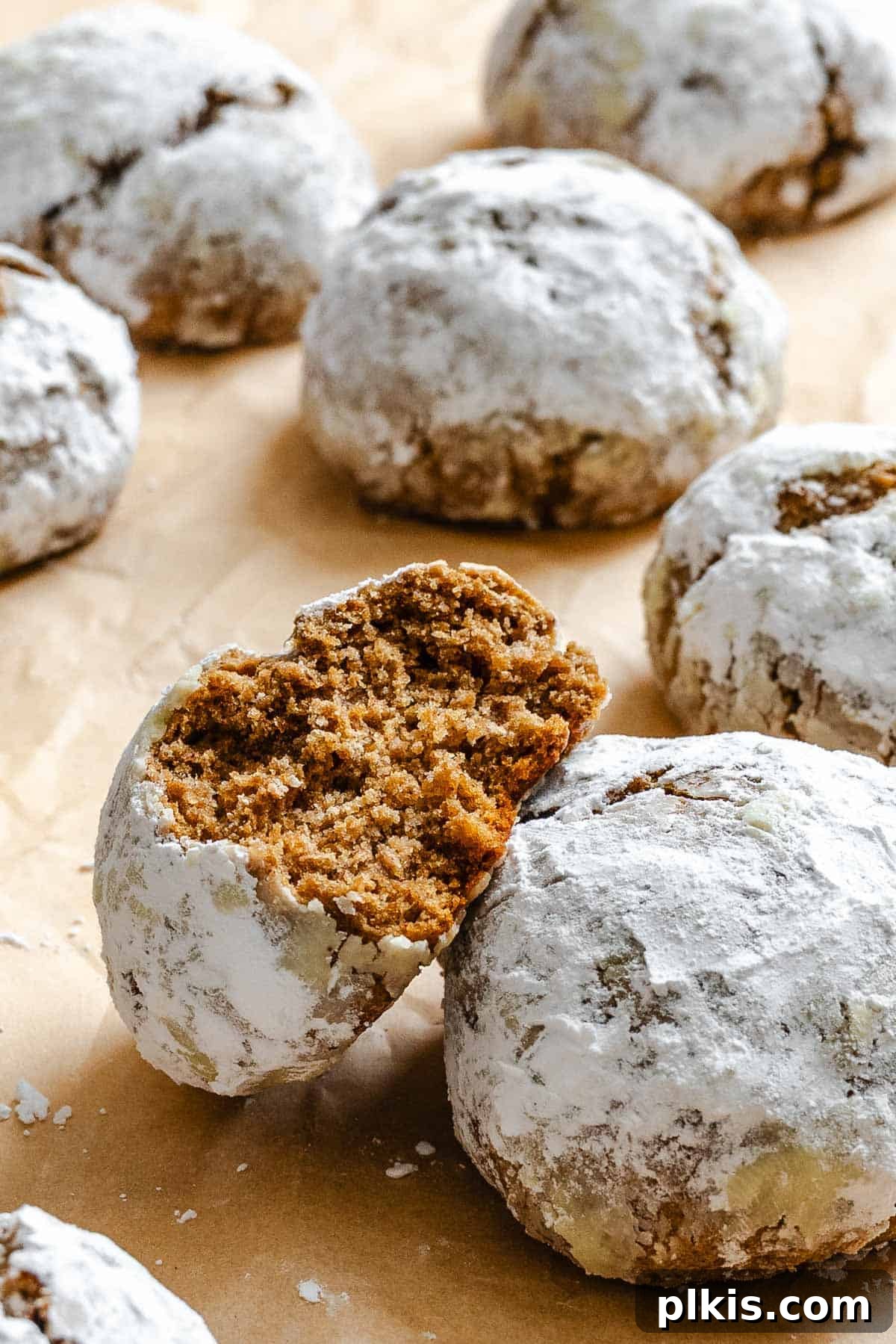 Festive Eggless Gingerbread Crinkle Cookies 10 Completed Gingerbread Crinkle Cookies (Eggless!) on a baking dish, perfectly baked with distinctive crinkles.