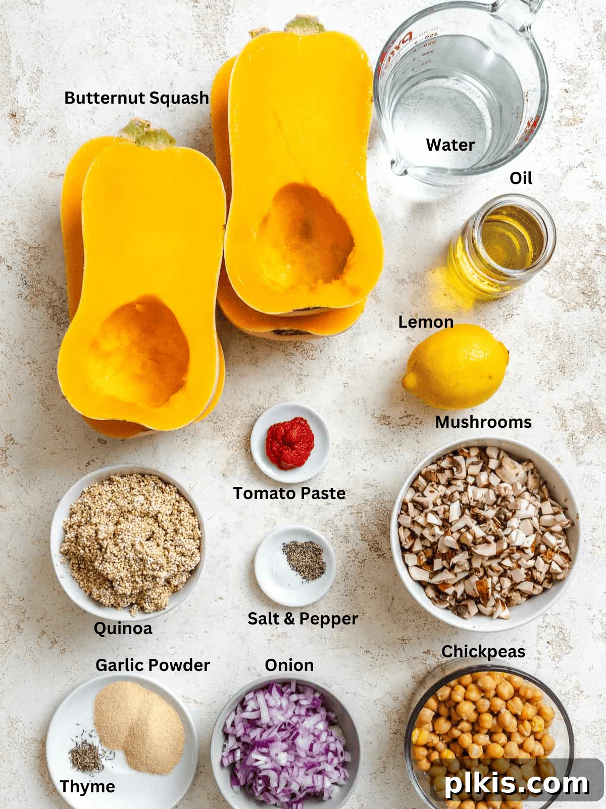 Wholesome Vegan Butternut Squash Boats 3 Ingredients for Vegan Stuffed Butternut Squash measured out on a white surface, showcasing butternut squash, quinoa, mushrooms, and chickpeas.