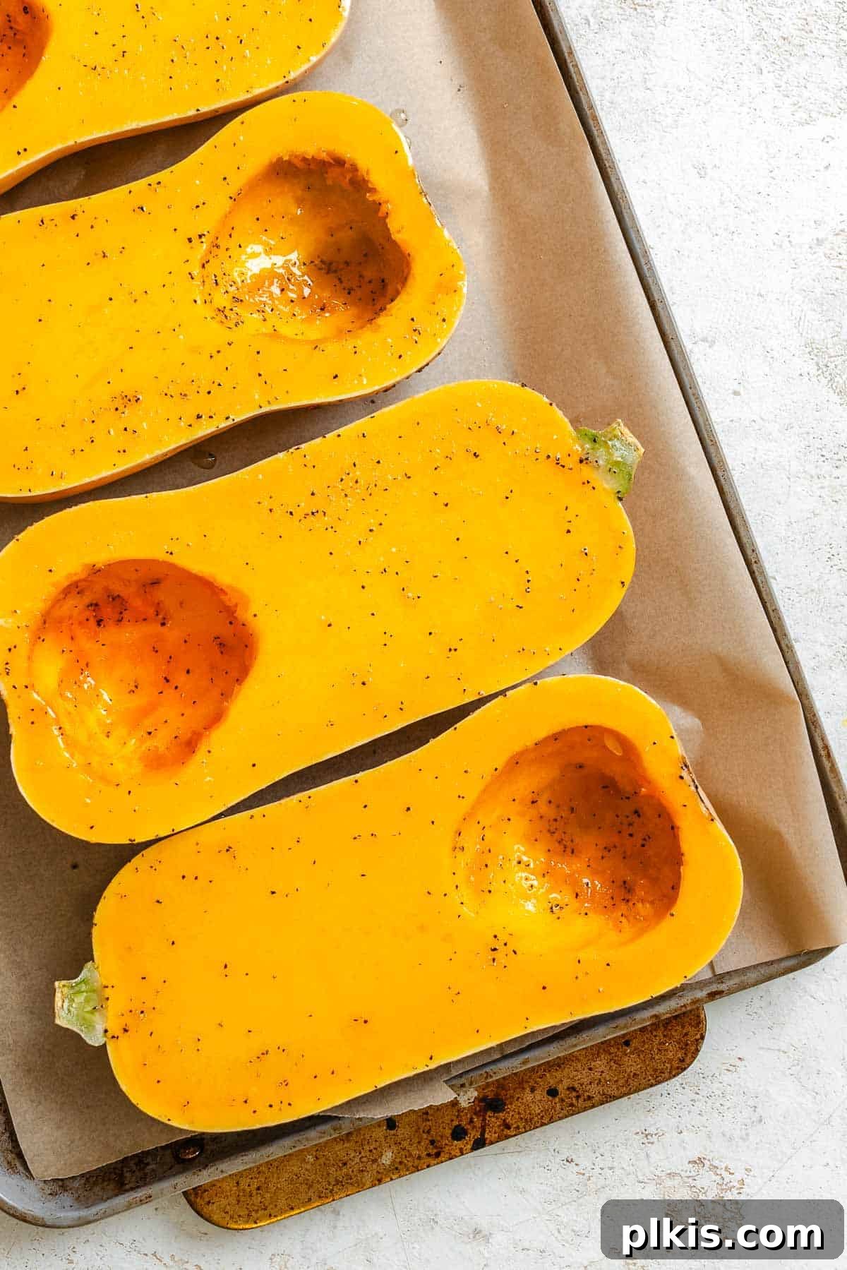 Wholesome Vegan Butternut Squash Boats 4 Process shot showing squash on a baking tray, ready for roasting.