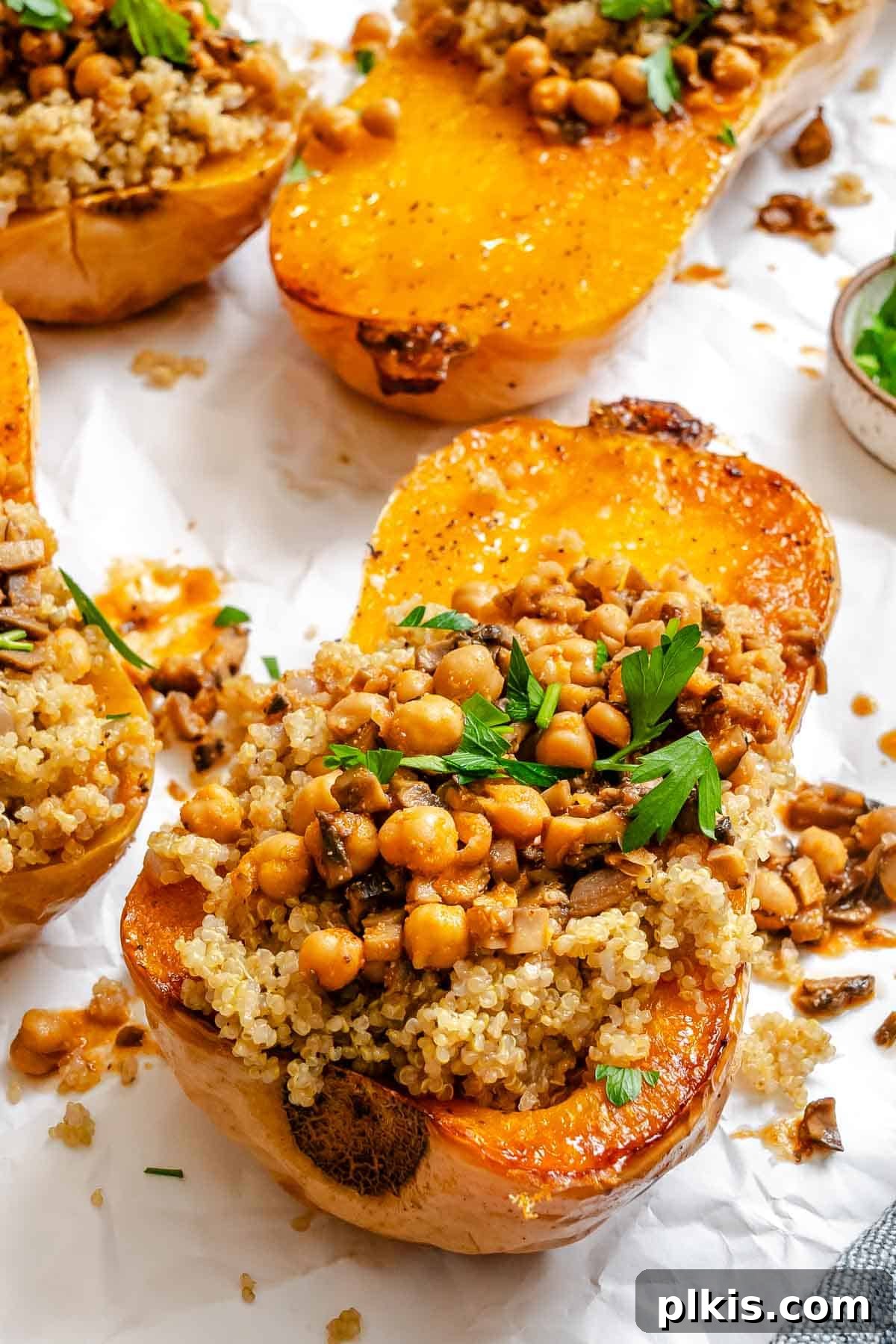 Wholesome Vegan Butternut Squash Boats 9 Completed Vegan Stuffed Butternut Squash on a white surface, ready to be served.