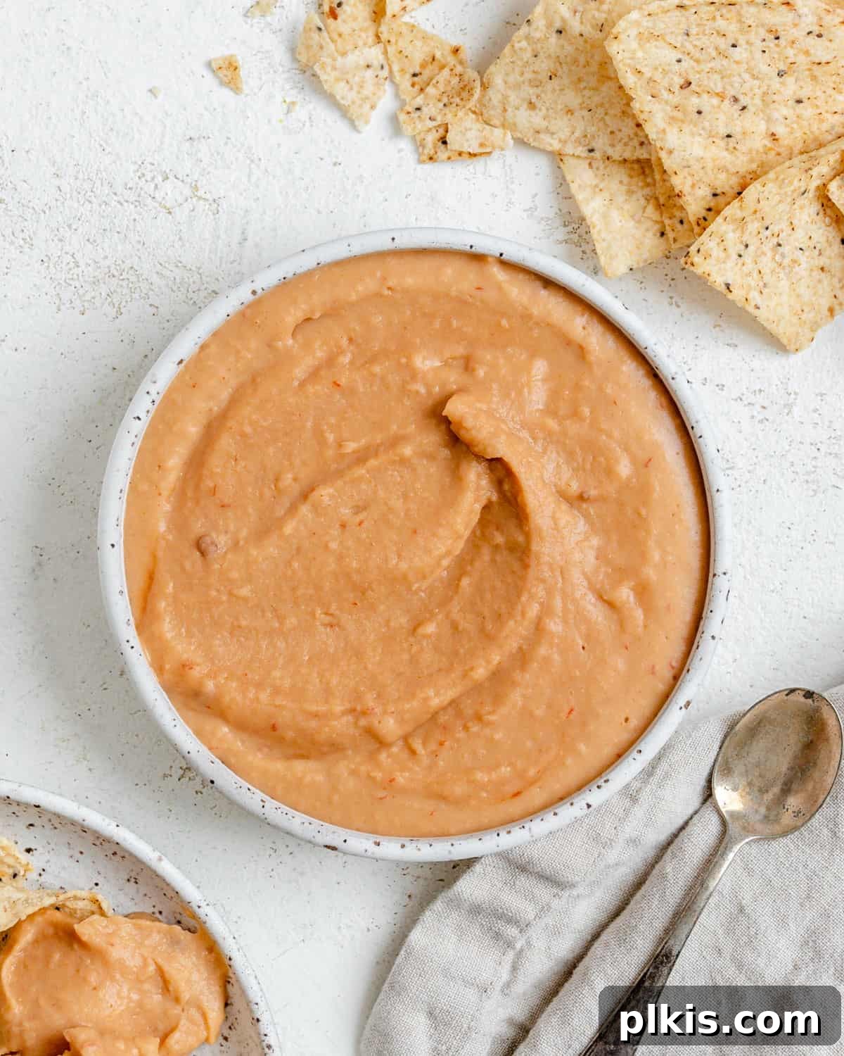Smoky Chipotle White Bean Dip 2 completed Spicy Chipotle White Bean Dip against a white surface, garnished with fresh cilantro