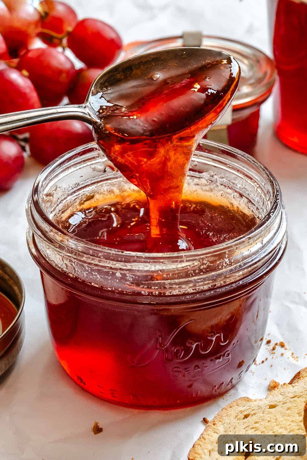 Effortless Pectin-Free Grape Jam 2 Completed Easy Grape Jam (No Pectin) in a jar with a spoonful of jam.