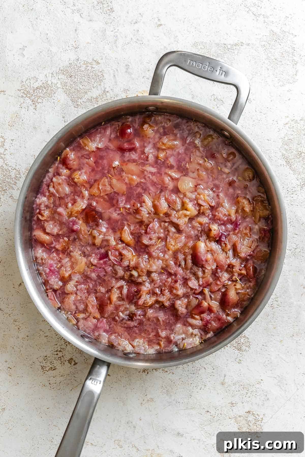 Effortless Pectin-Free Grape Jam 4 Process shot showing grapes cooking in pot.