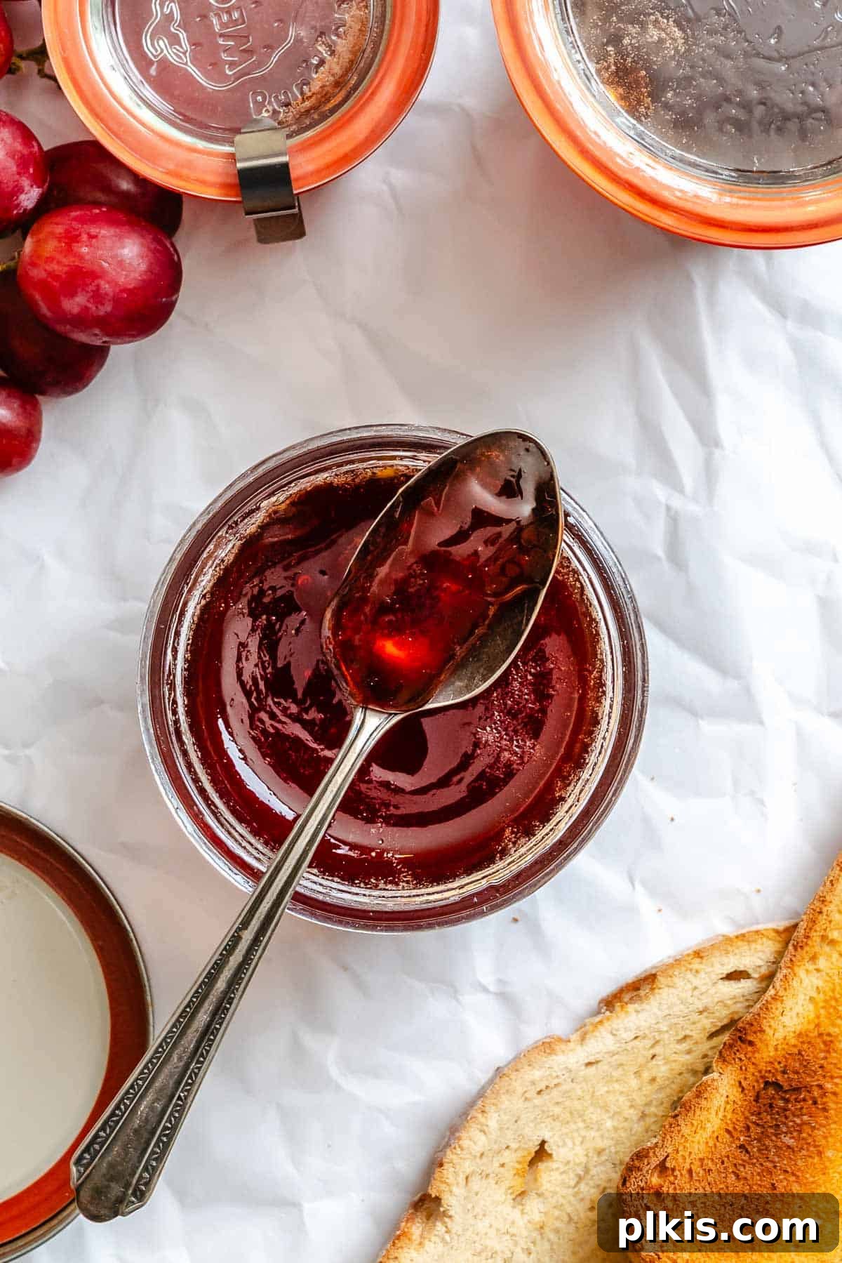 Effortless Pectin-Free Grape Jam 8 Completed Easy Grape Jam (No Pectin) in a jar with a spoonful of jam.