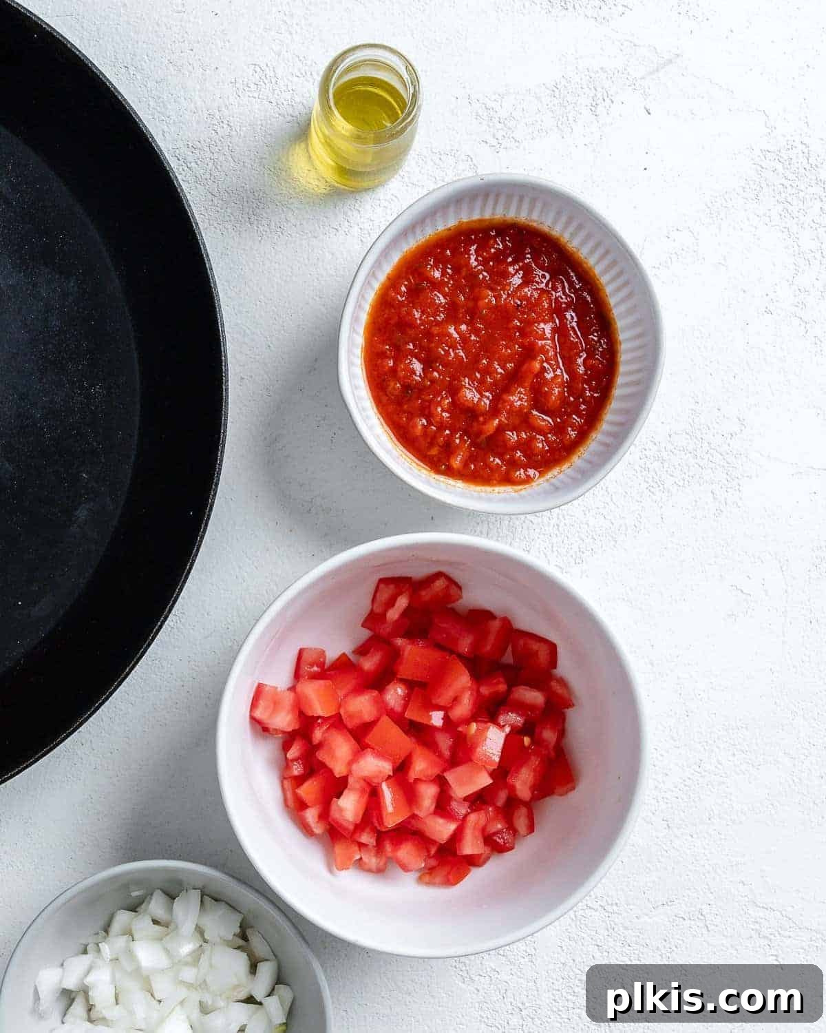 Portobello Pizza Caps 5 diced tomatoes and marinara sauce in individual bowls against white surface