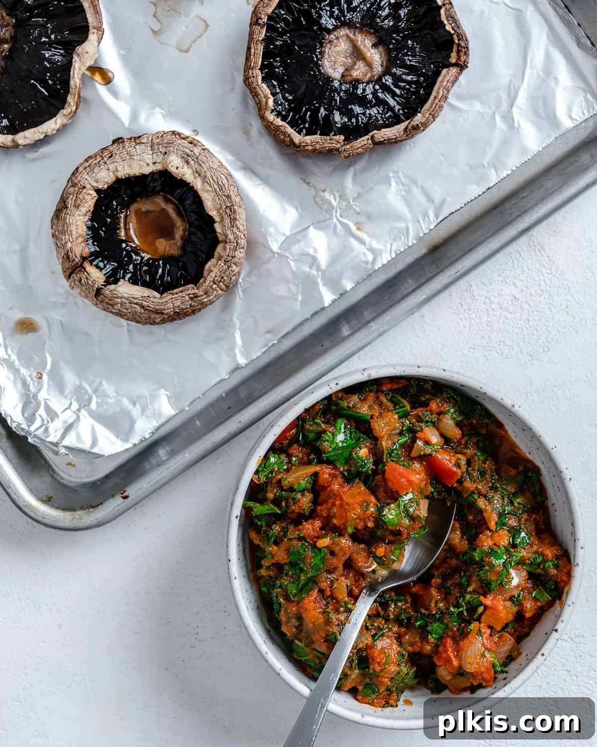 Portobello Pizza Caps 8 pan of sauce alongside baking tray of portobello mushrooms against a white background