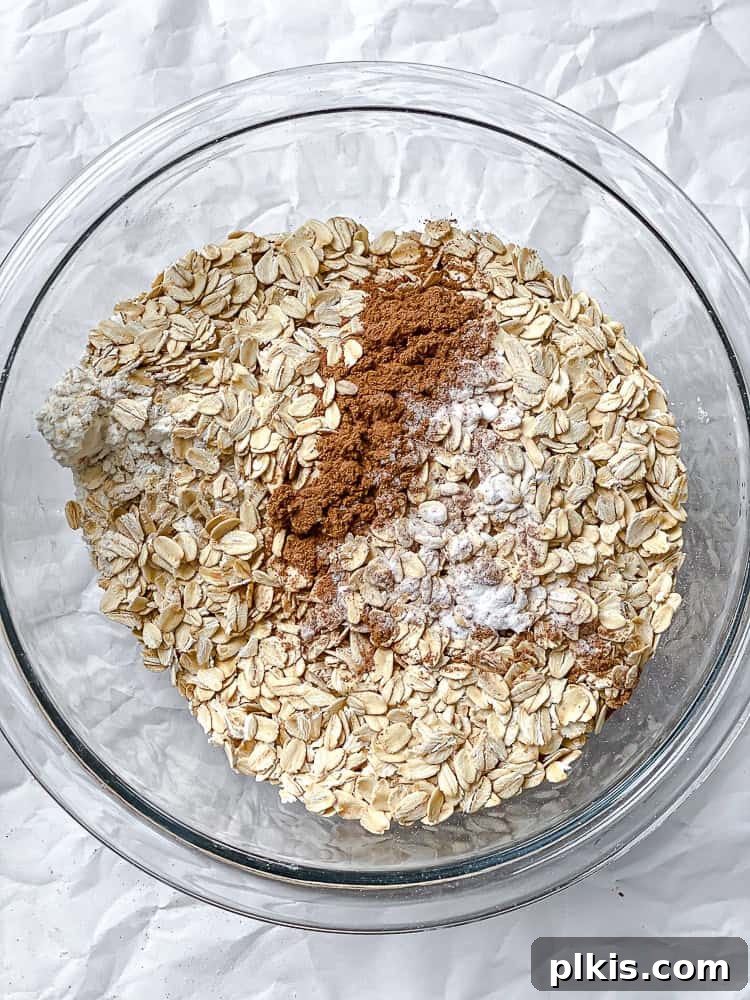 Spiced Pumpkin Oatmeal Cookies 5 Process shot showing all wet ingredients and some dry ingredients mixed in a bowl, before the final addition of oats and flour.