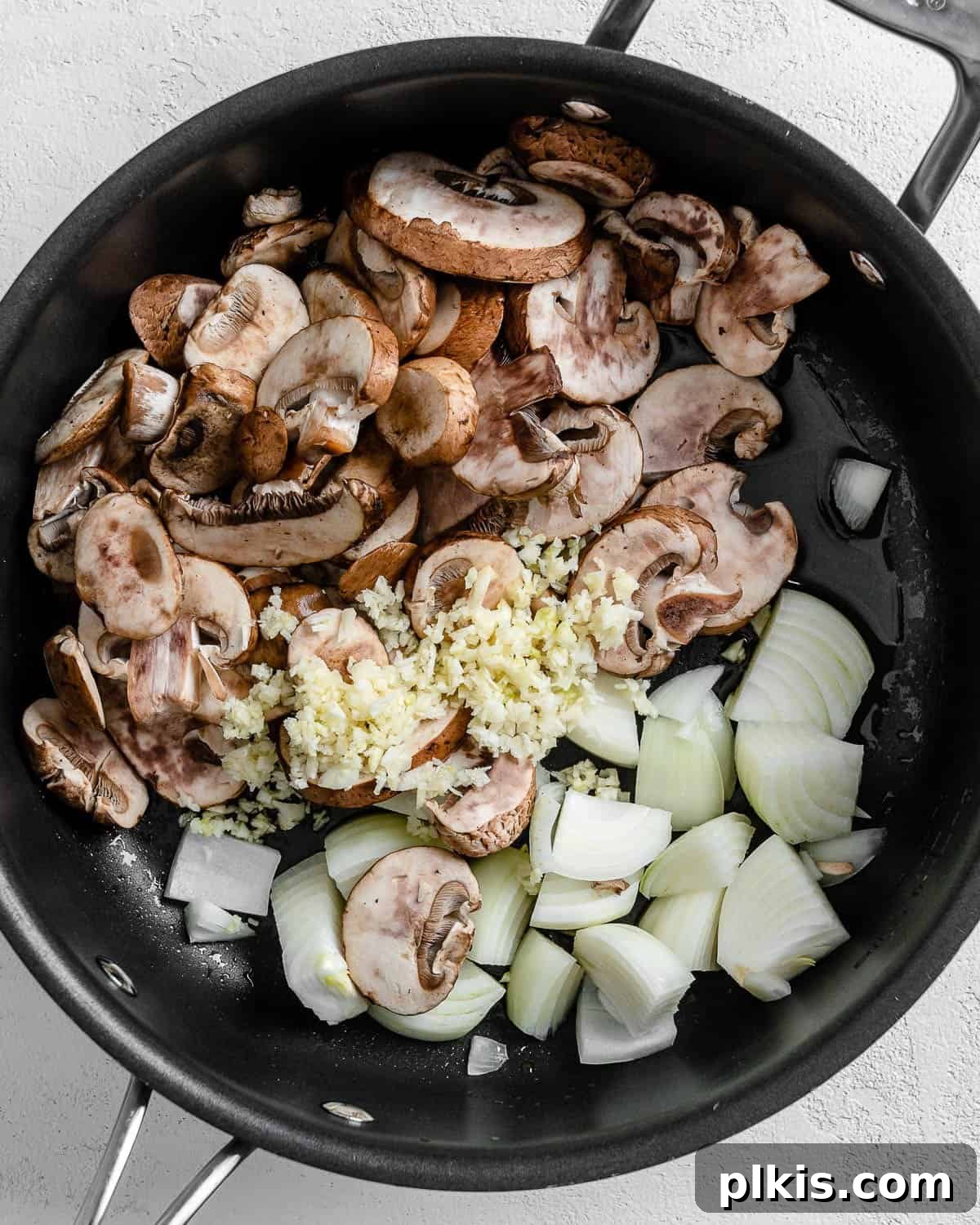 Creamy Vegan Garden Risotto 4 ingredients for vegan risotto added to black skillet