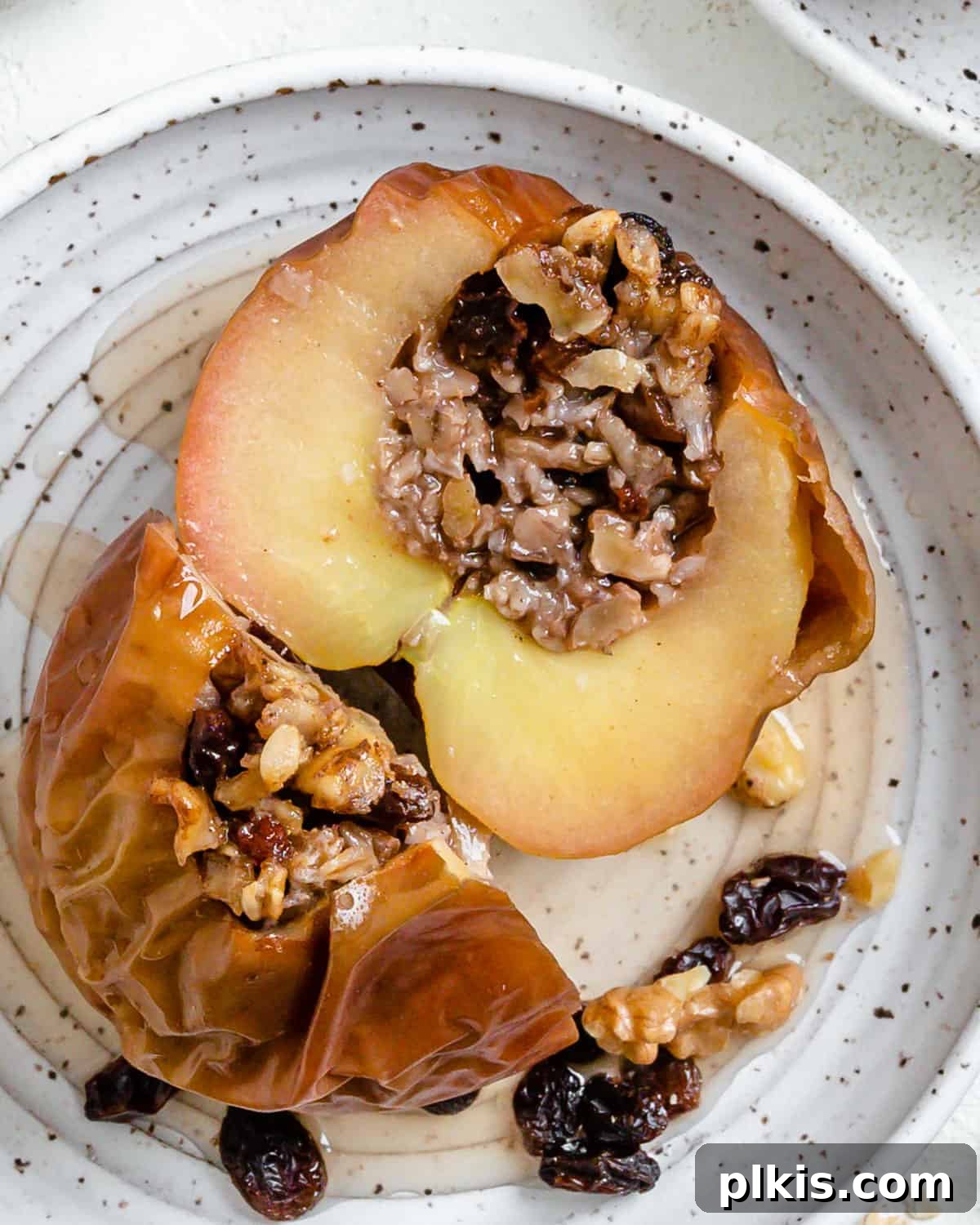 Baked Apple Delights 9 Completed stuffed baked apples on white plates against a white background, ready to be served and enjoyed.