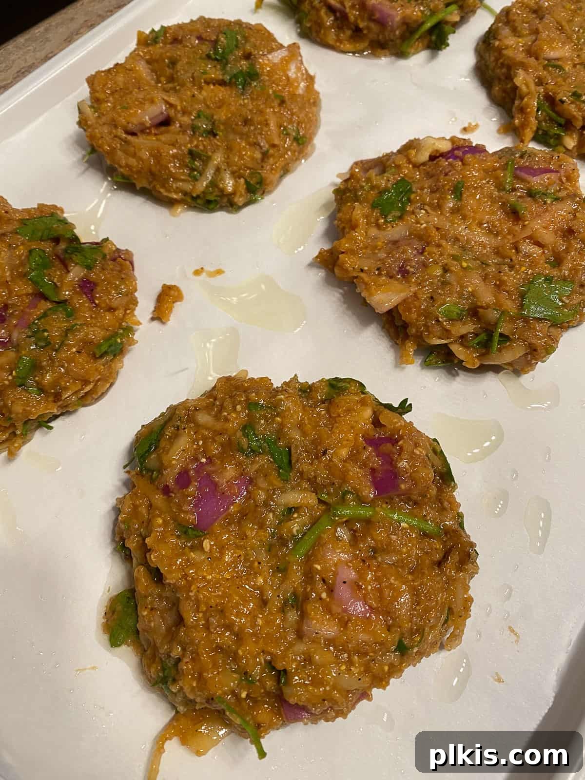 Wholesome Red Lentil Burgers 19 Process shot of forming the lentil mixture into several small patties, perfectly shaped for baking.