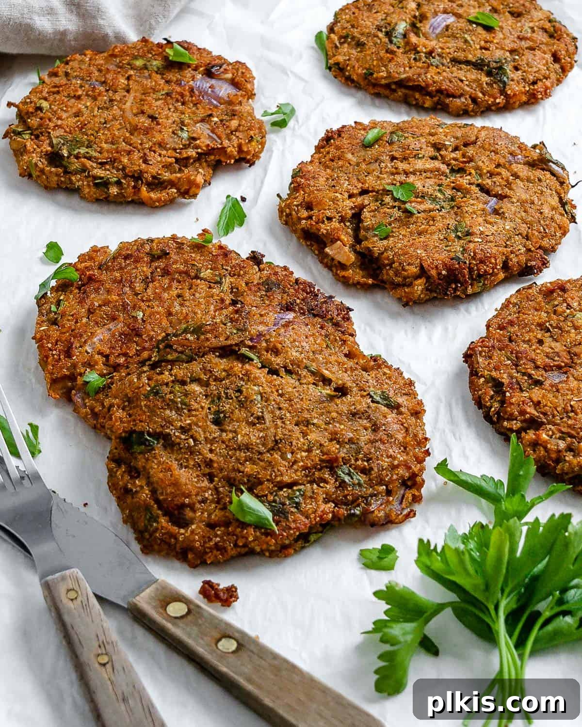 Wholesome Red Lentil Burgers 20 Completed Easy Red Lentil Patties spread out on a white surface, ready to be served or stored.