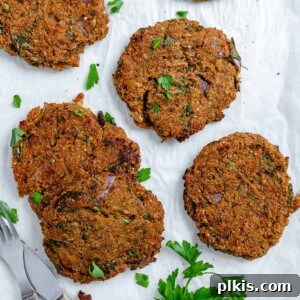 Wholesome Red Lentil Burgers 21 Completed Easy Red Lentil Patties spread out on a white surface.