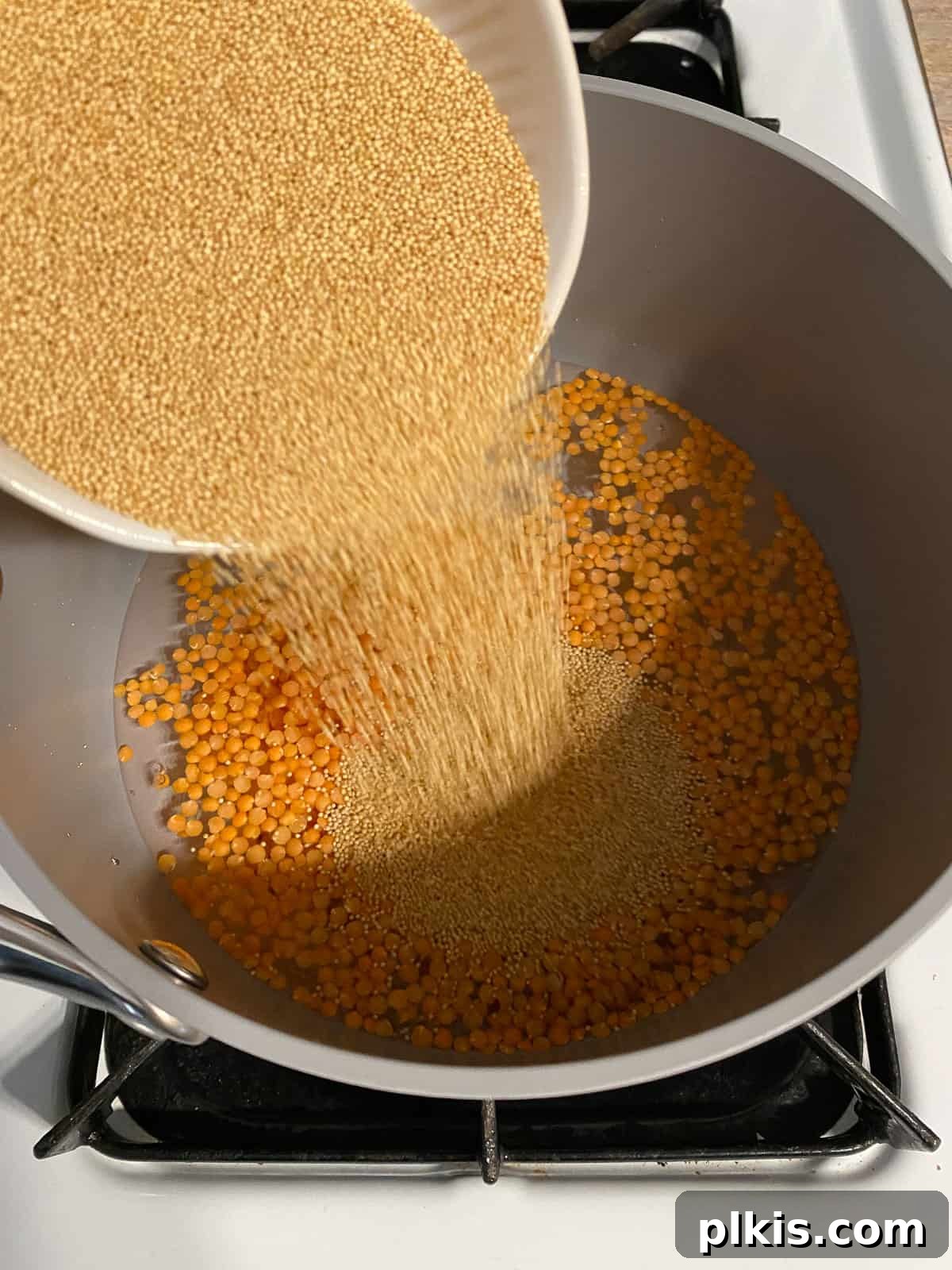 Wholesome Red Lentil Burgers 6 Process shot of adding red lentils to a bowl, combining with amaranth for cooking.