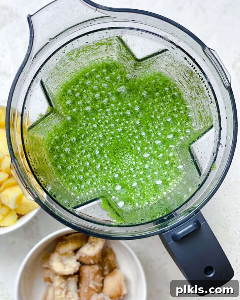 Emerald Pineapple Splash 7 Process shot after blending all ingredients for Kale Pineapple Smoothie, showing a smooth green mixture.