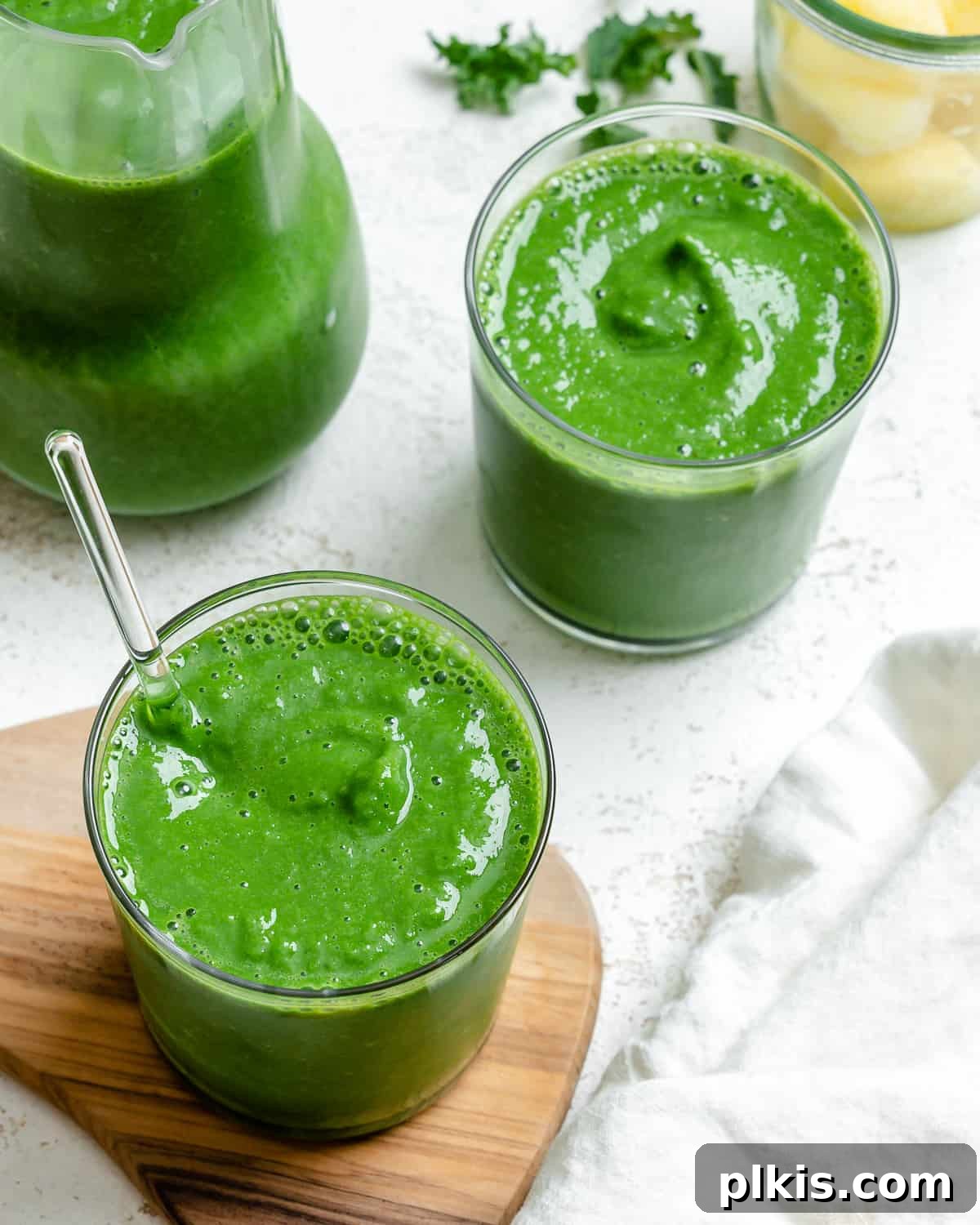 Emerald Pineapple Splash 8 Two glasses of completed Kale Pineapple Smoothie, vibrant and refreshing.