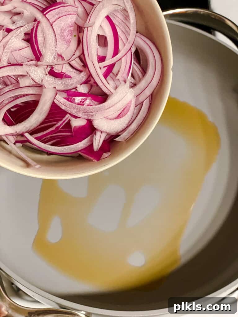 Vibrant Veggie Noodle Medley 4 process shot of adding onions to pan