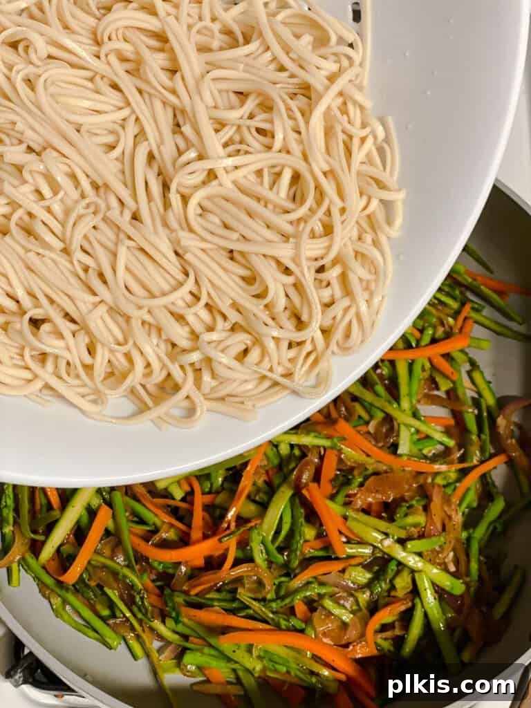 Vibrant Veggie Noodle Medley 10 process shot of adding noodles to pan