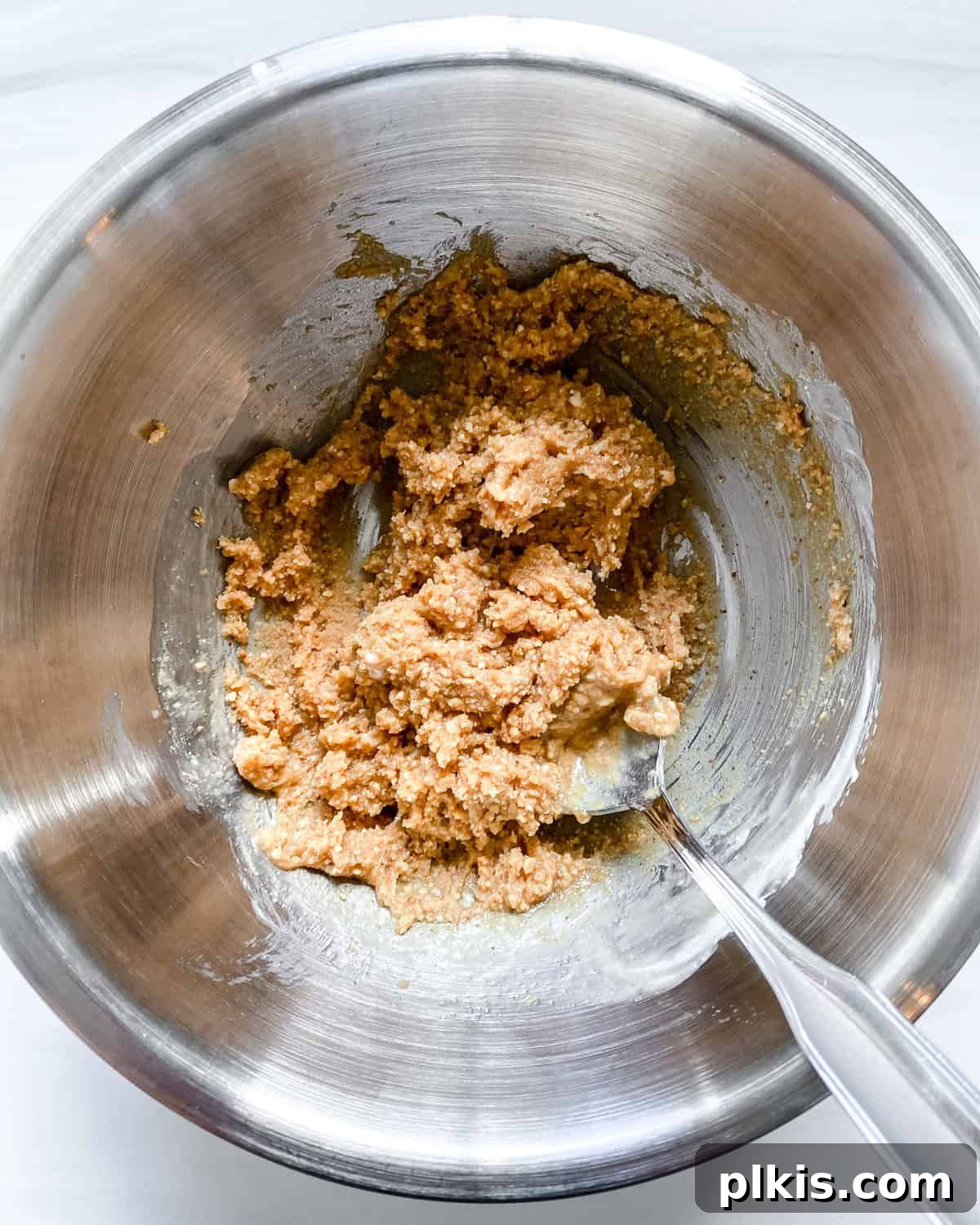 Frightfully Delicious Peanut Butter Spiders 4 Process shot showing mixing peanut butter and sugar together in a large bowl.