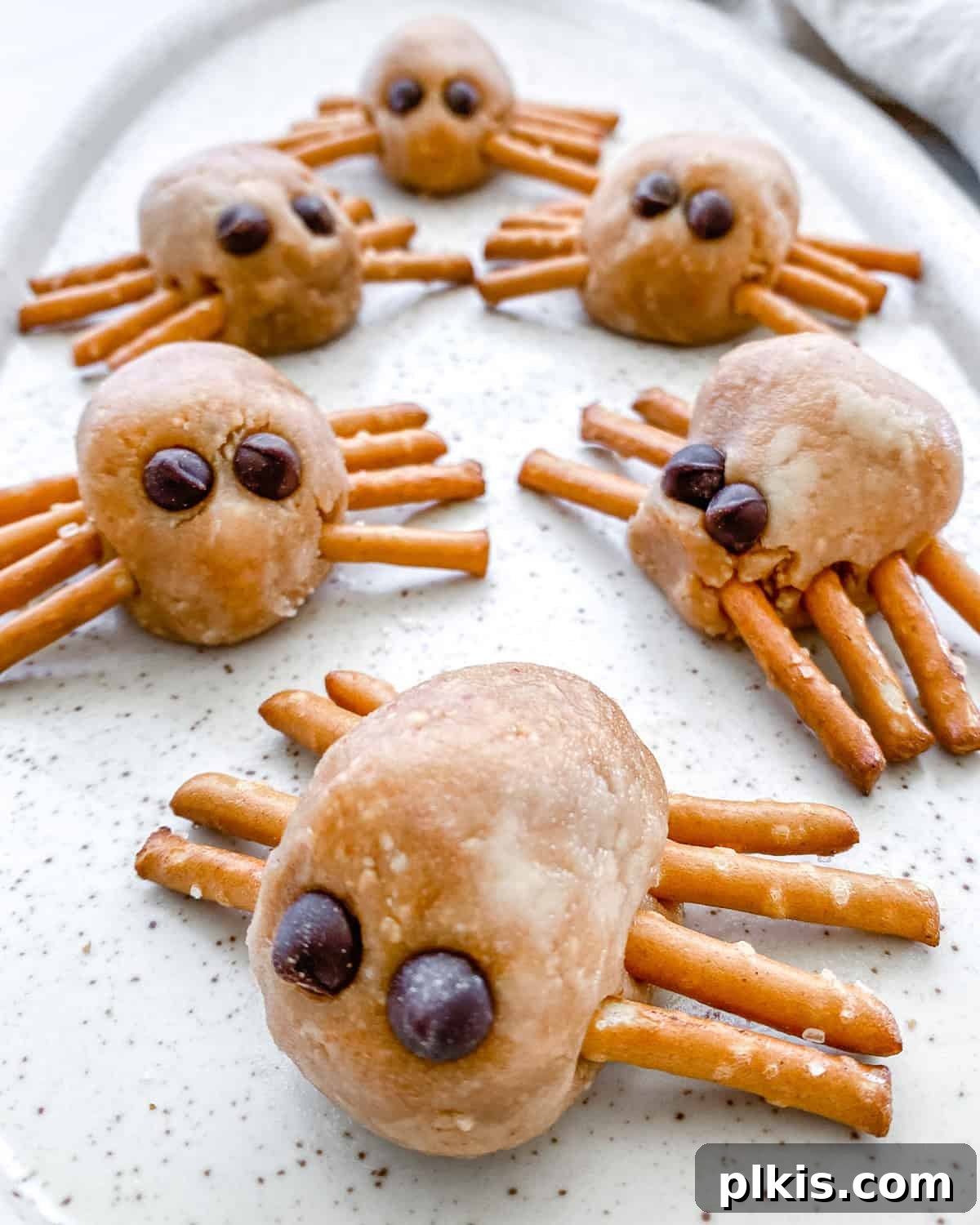 Frightfully Delicious Peanut Butter Spiders 7 Completed Halloween Peanut Butter Spiders arranged neatly on a white platter, ready for a spooky celebration.