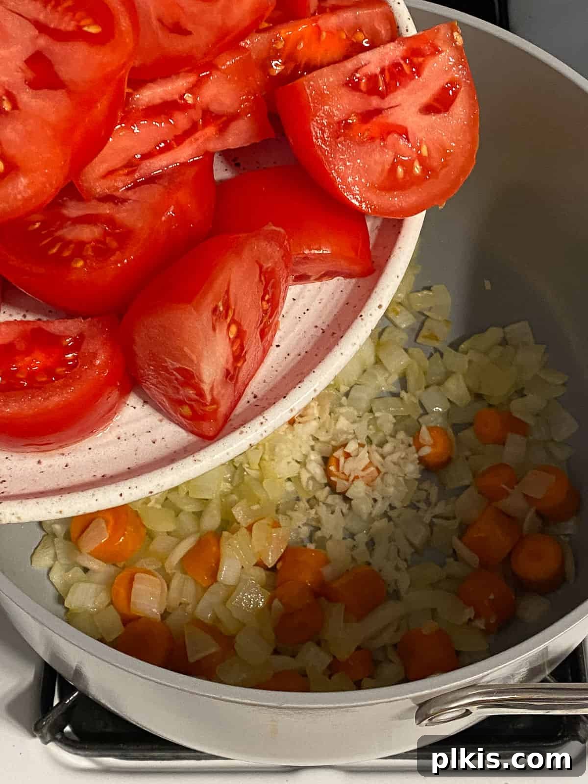 Velvety Vegan Tomato Basil Soup 6 process of adding tomatoes to pan