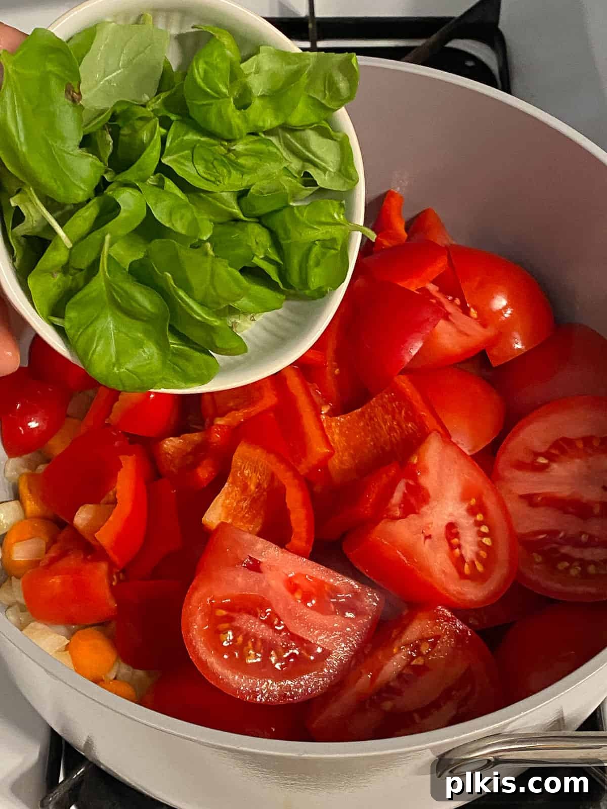 Velvety Vegan Tomato Basil Soup 8 process of adding basil to pan