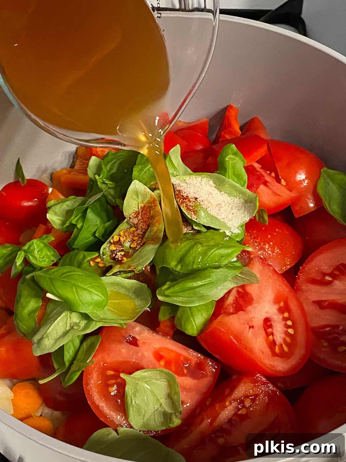Velvety Vegan Tomato Basil Soup 10 process of adding vegetable broth to pan