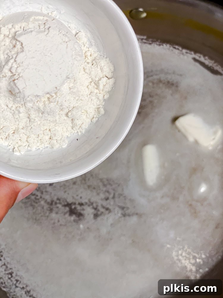 Golden Butternut Macaroni 6 Process shot showing flour being added to melted vegan butter in a pan to create a roux.