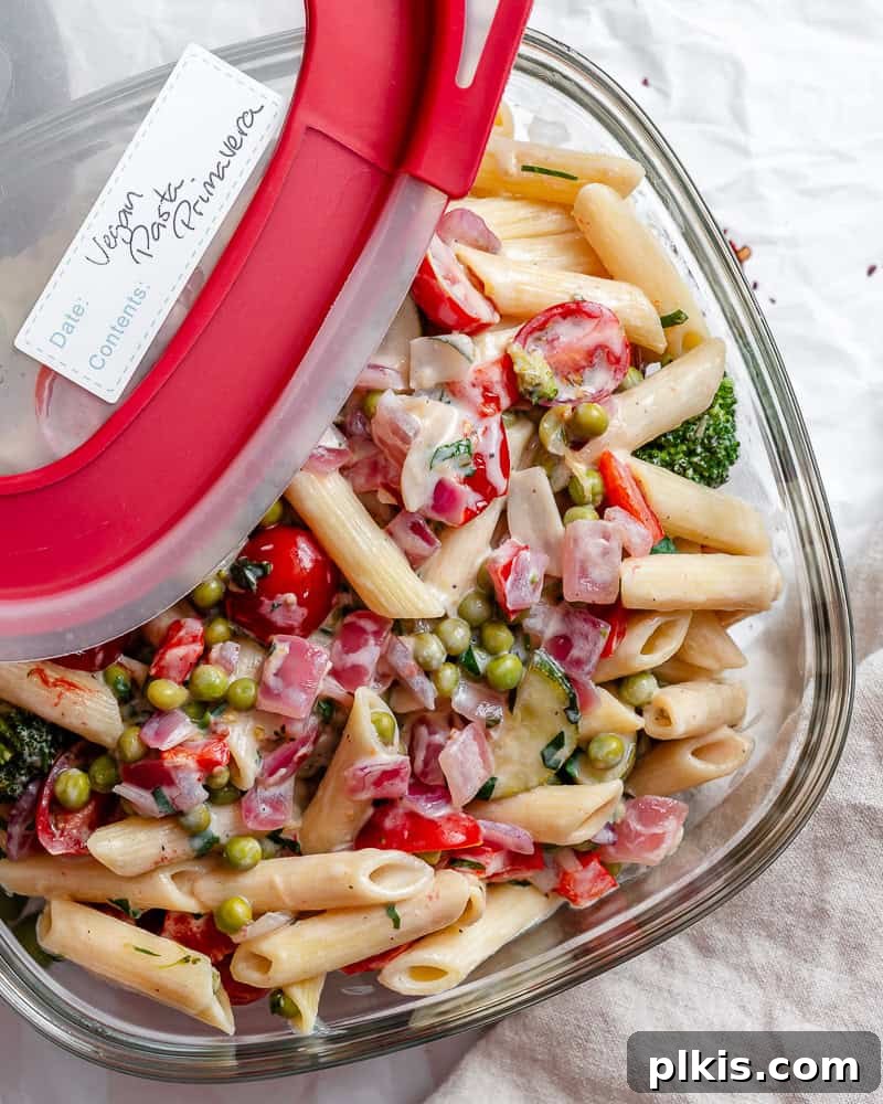 Vibrant Vegan Primavera Pasta 14 Leftover vegan pasta primavera neatly stored in a glass airtight container for the refrigerator.