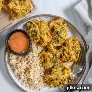 completed broccoli and onion pakora plated with rice and a sauce
