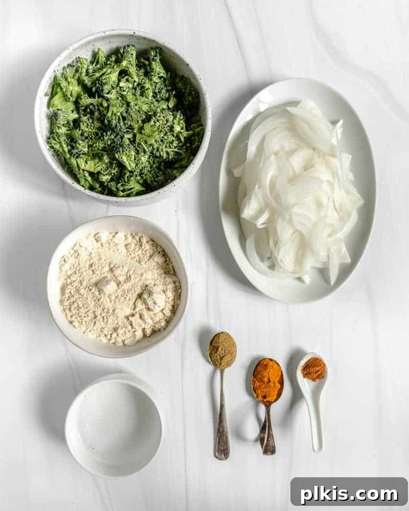 Crispy Broccoli Onion Pakora Bites 3 ingredients for broccoli and onion pakora on a white surface