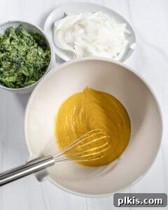process of broccoli and onion pakora wet ingredients being mixed in a bowl with ingredients on the side