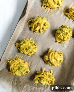 process of broccoli and onion pakora on a baking sheet prior to being baked