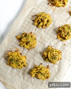 process of broccoli and onion pakora on a baking sheet prior to being baked