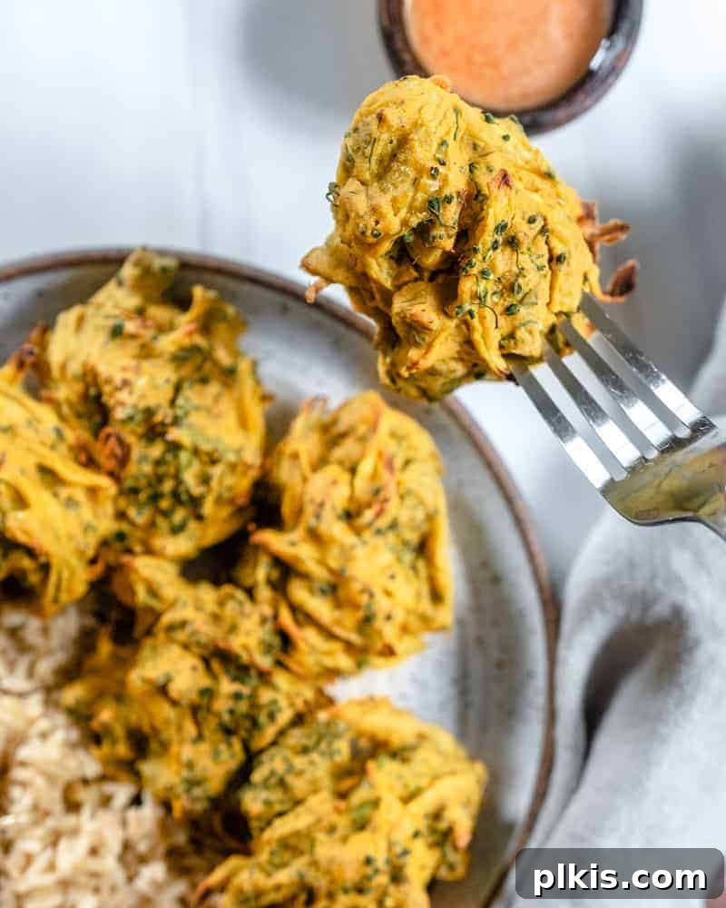 Crispy Broccoli Onion Pakora Bites 9 completed broccoli and onion pakora plated with a close up of one picked up with a fork