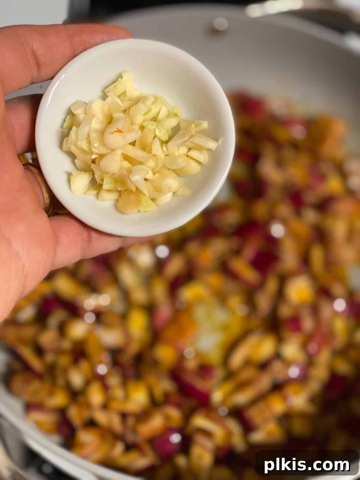 One-Pan Roasted Root Vegetable Medley 6 Process shot of onions and garlic gently sautéing in the skillet until soft and fragrant.