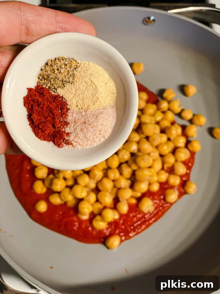 Creamy Tandoori Chickpea Curry Vegan 7 process shot of adding spices to pan